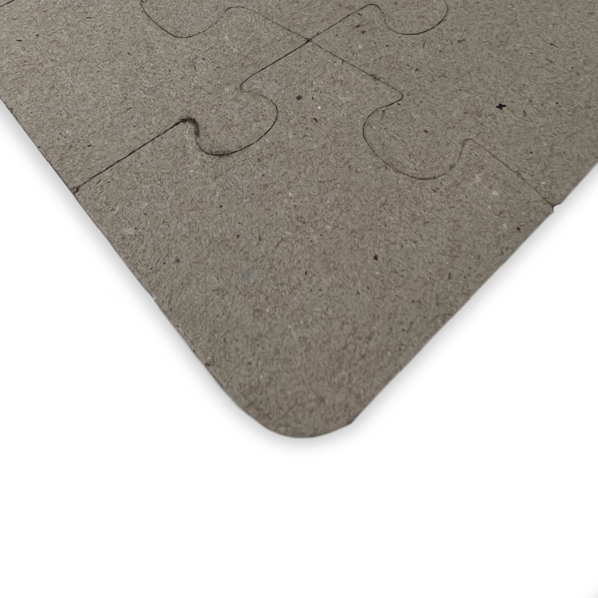 Back side of puzzle showing thick chipboard material and rounded corners